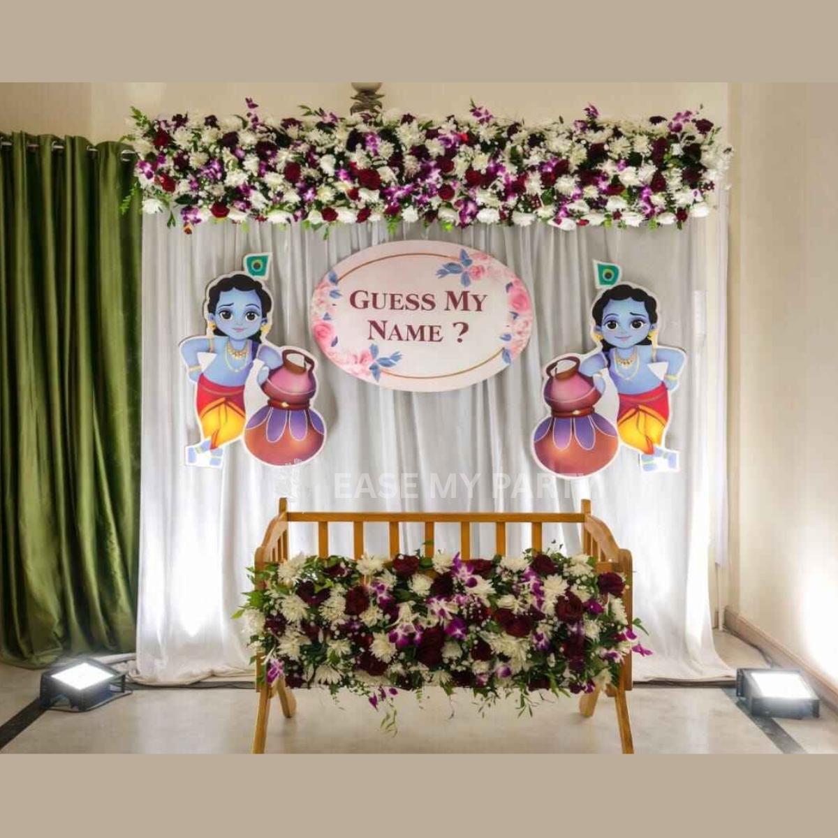 Little Krishna theme naming ceremony decor in Bangalore with 8x8ft white lycra backdrop, natural purple orchids and white chrysanthemums, sunboard name board, Krishna cutouts, and cradle rental by Ease My Party